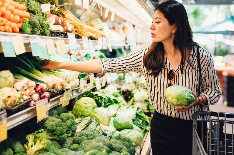 Woman shopping for produce at the grocery store